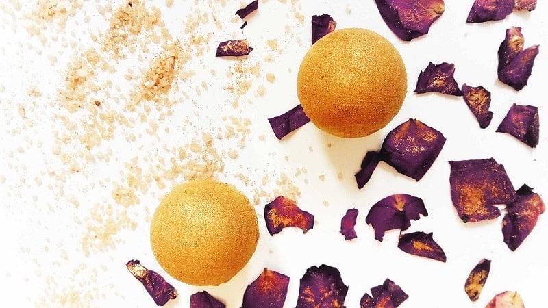 yellow DIY bath bombs covered in golden mica powder