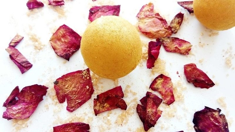 DIY moisturizing bath bomb fully painted with golden mica powder