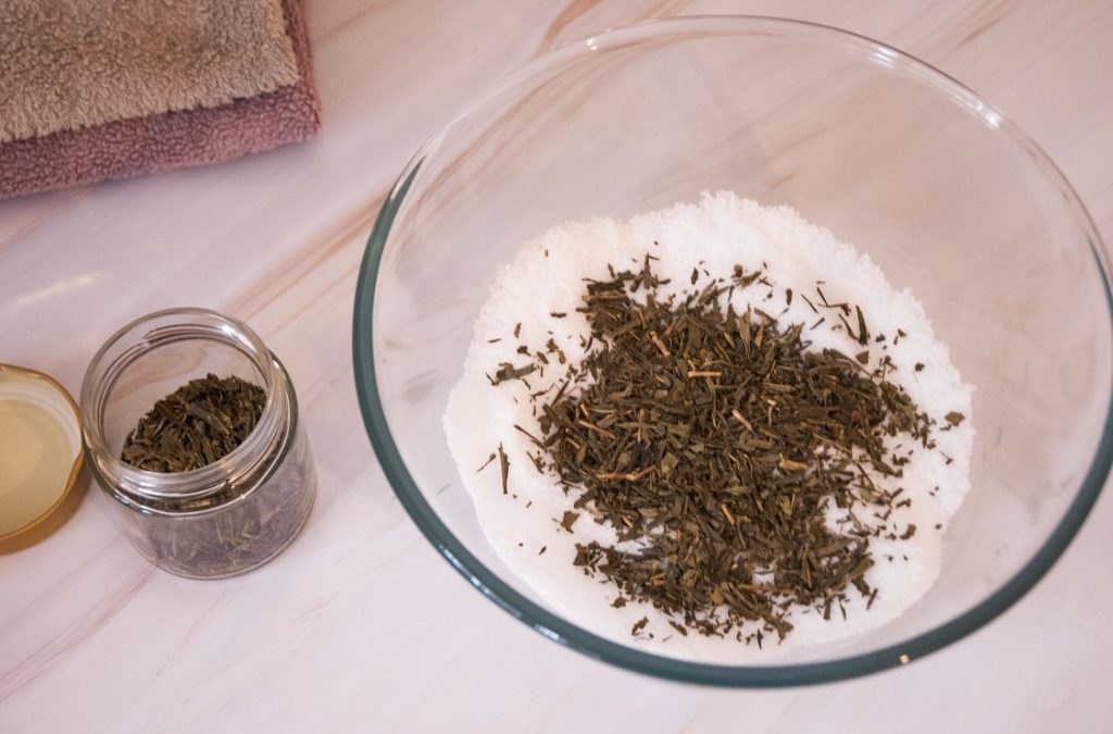 adding green tea leaves to DIY antifungal te atree oil foot soak diy foot soak in the bowl with added green tea leaves
