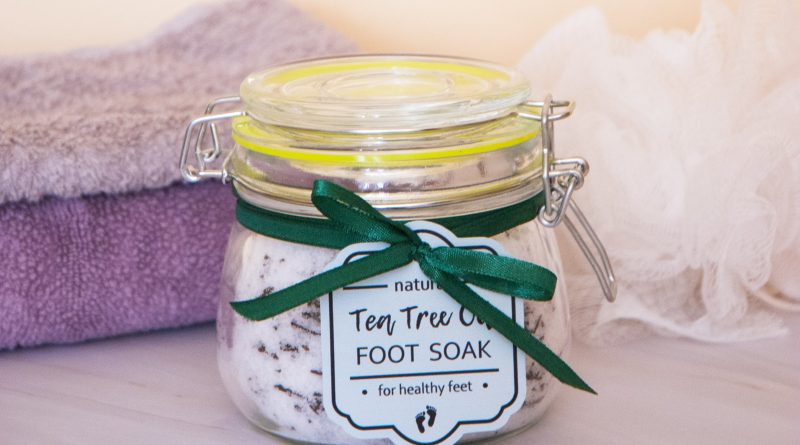Homemade tea tree oil foot soak with epsom salt in the jar with a green gift tag