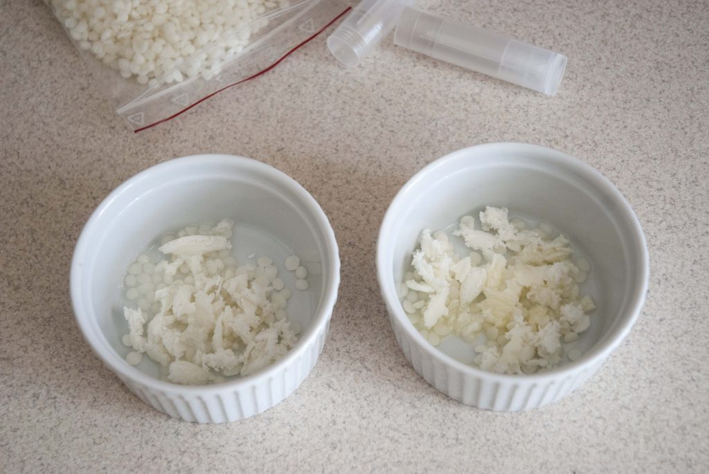 diy lip balm ingredients white beeswax, shea butter and sweet almond oil in the heat proof bowls
