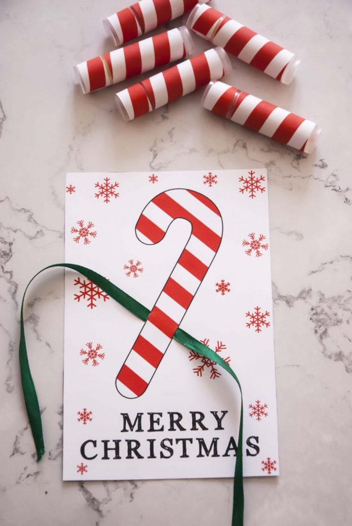 making Christmas card for lip balms DIY christmas lip balms next to unfinished lip balm christmas card