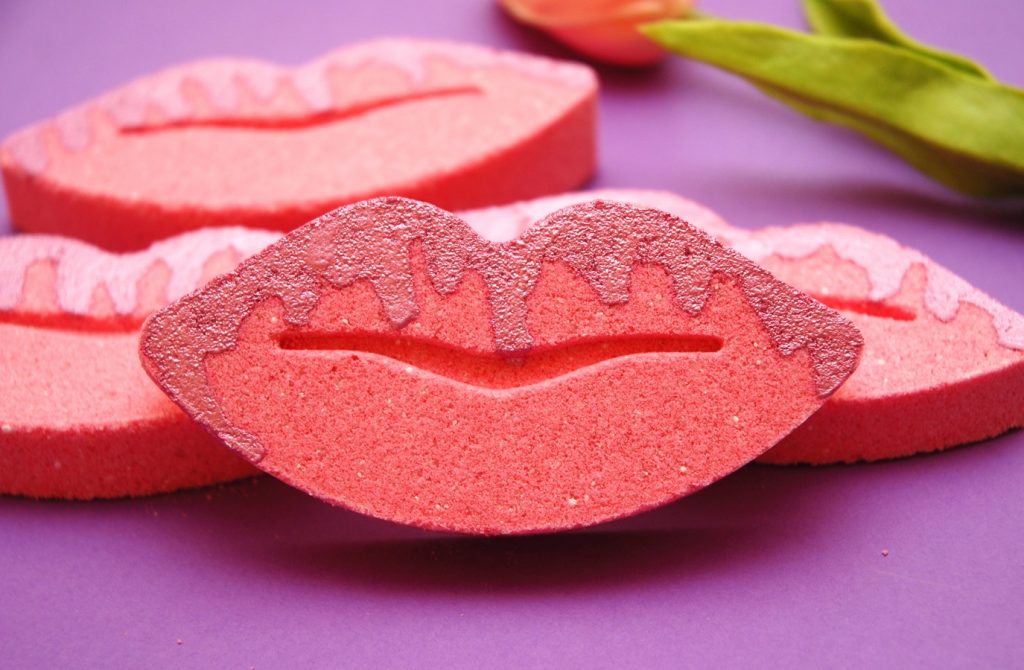 Pink girly DIY bath bombs in a shape of lips with a mica drizzle