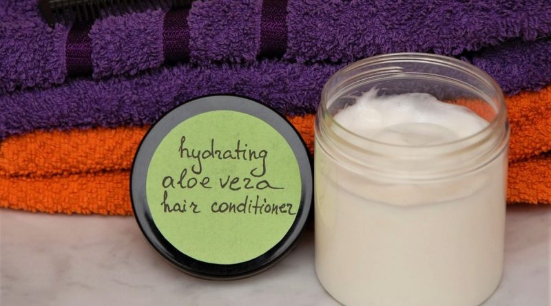 A jar with homemade hair conditioner next to towels