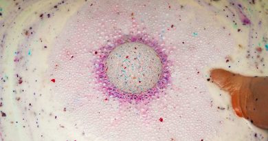“A Little Bit of Everything” Bath Bomb Recipe purple diy foaming bath bomb with rose petals in water