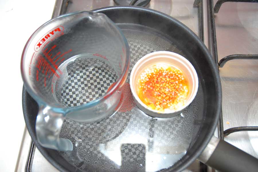 melting ingredients for homemade body lotion in a water bath