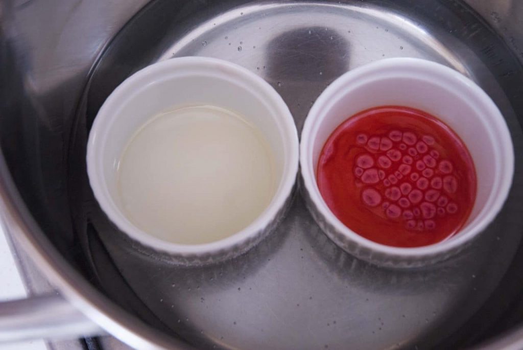 adding red mica powder to make red white layered candy cane lip balm