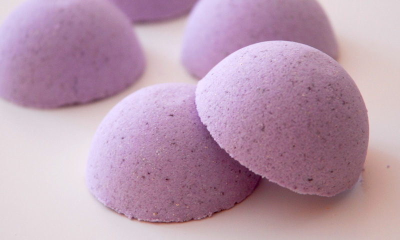 Purple DIY shower steamer with lavender essential oils made with halves of bath bomb mold