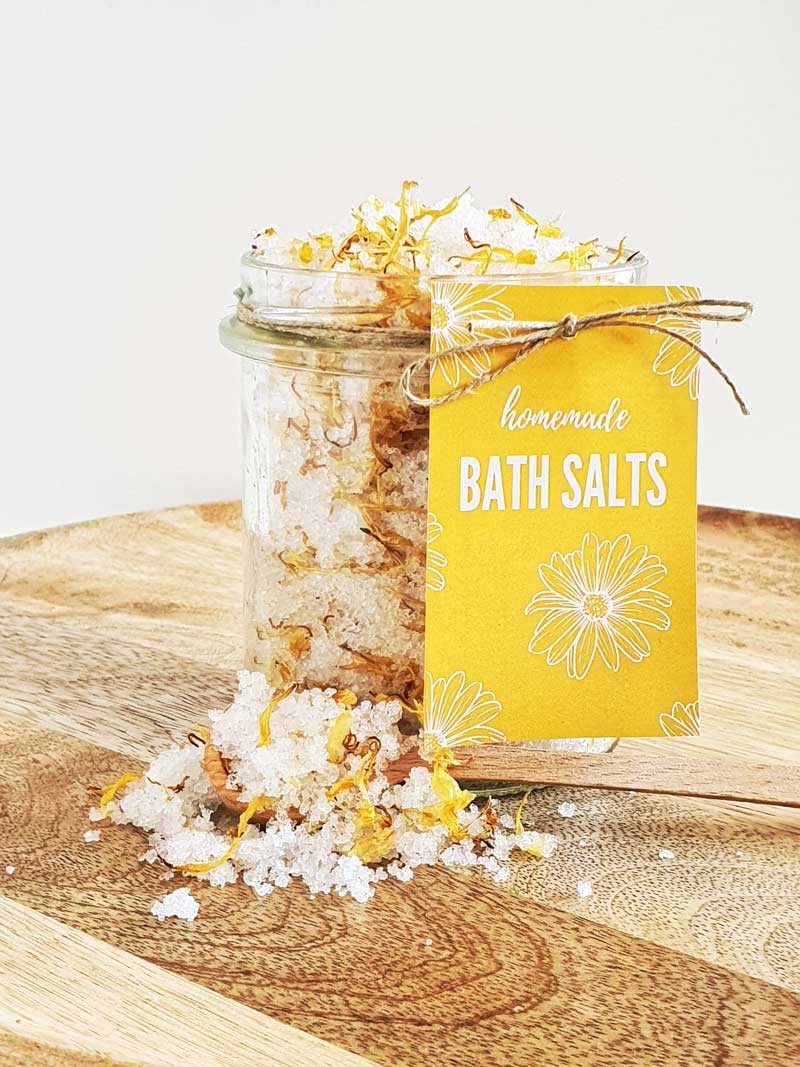 homemade calendula bath salts in a jar with a yellow label
