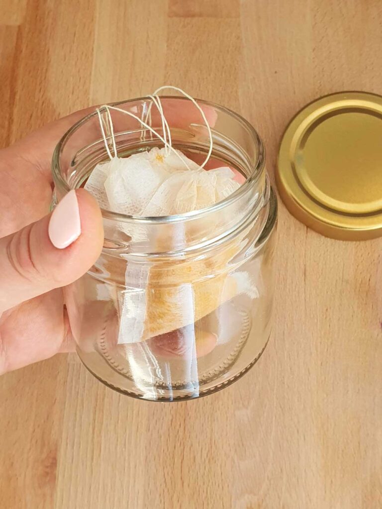 placing turmeric powder into glass jars