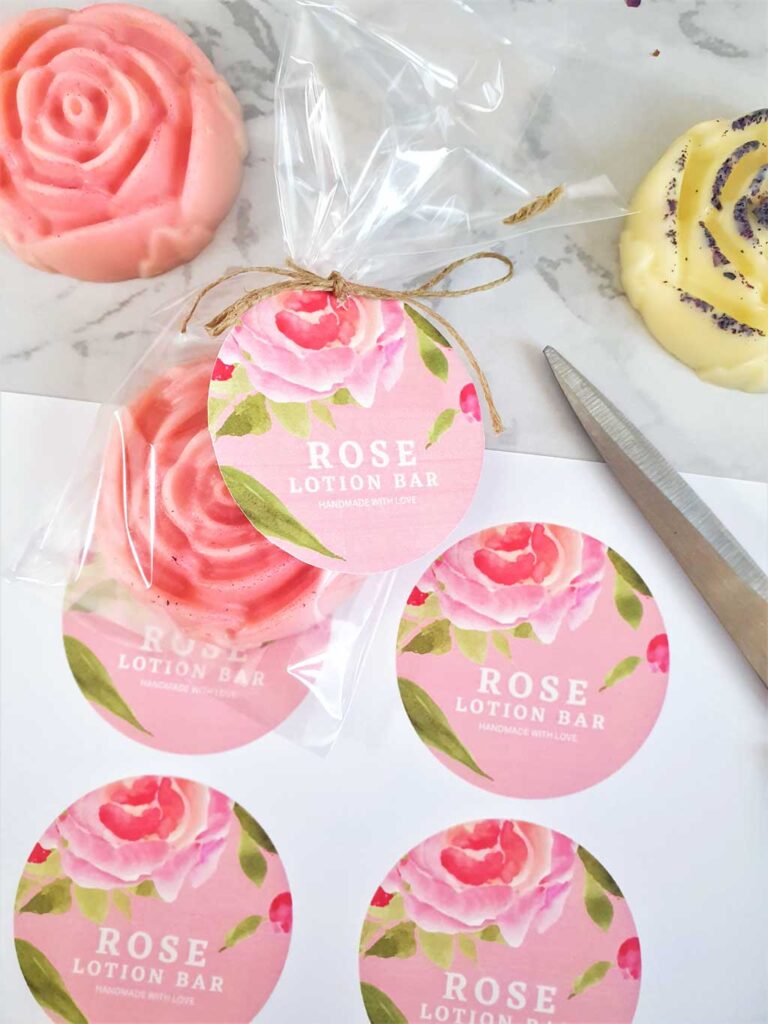 packaging rose lotion bars in a cellophane bag with a label